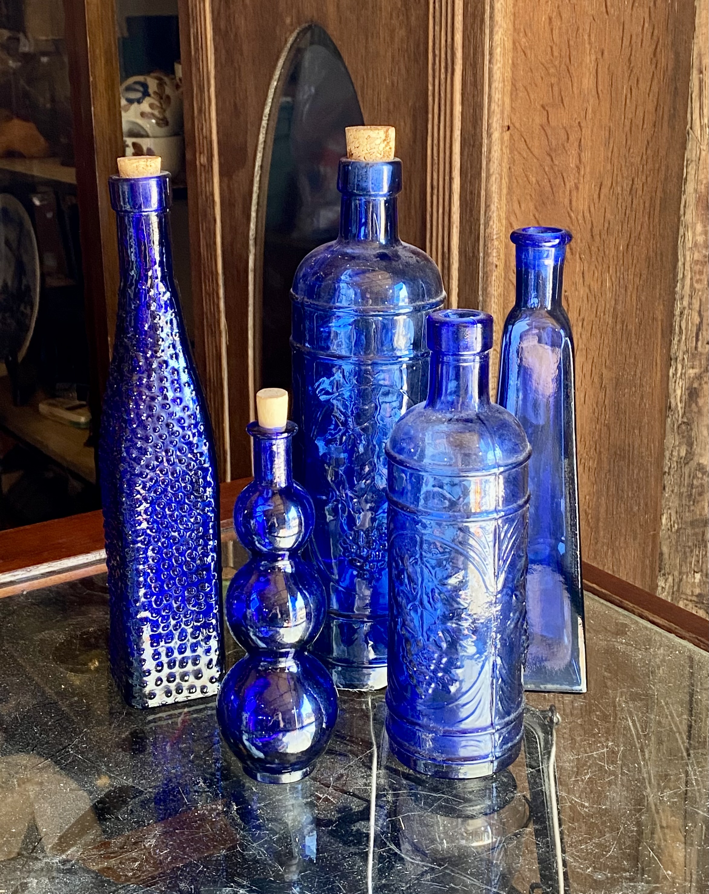Lot 219: Collection of 5 Vintage Cobalt Blue Decorative Glass Bottles with Corks (20cm - 30cm)